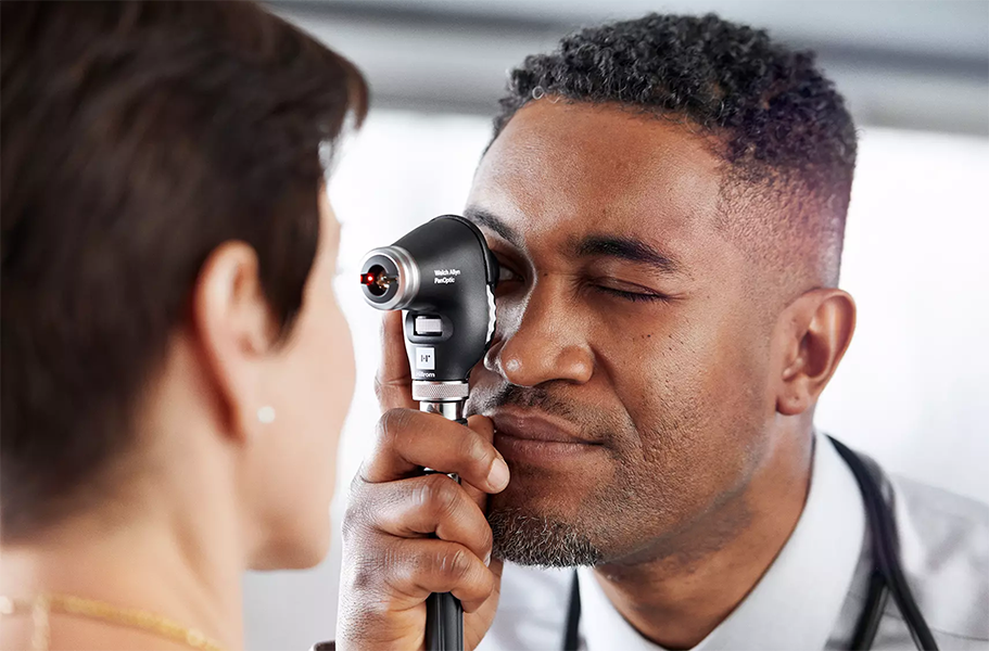 Welch Allyn PanOptic Ophthalmoscope Head in use 2 men